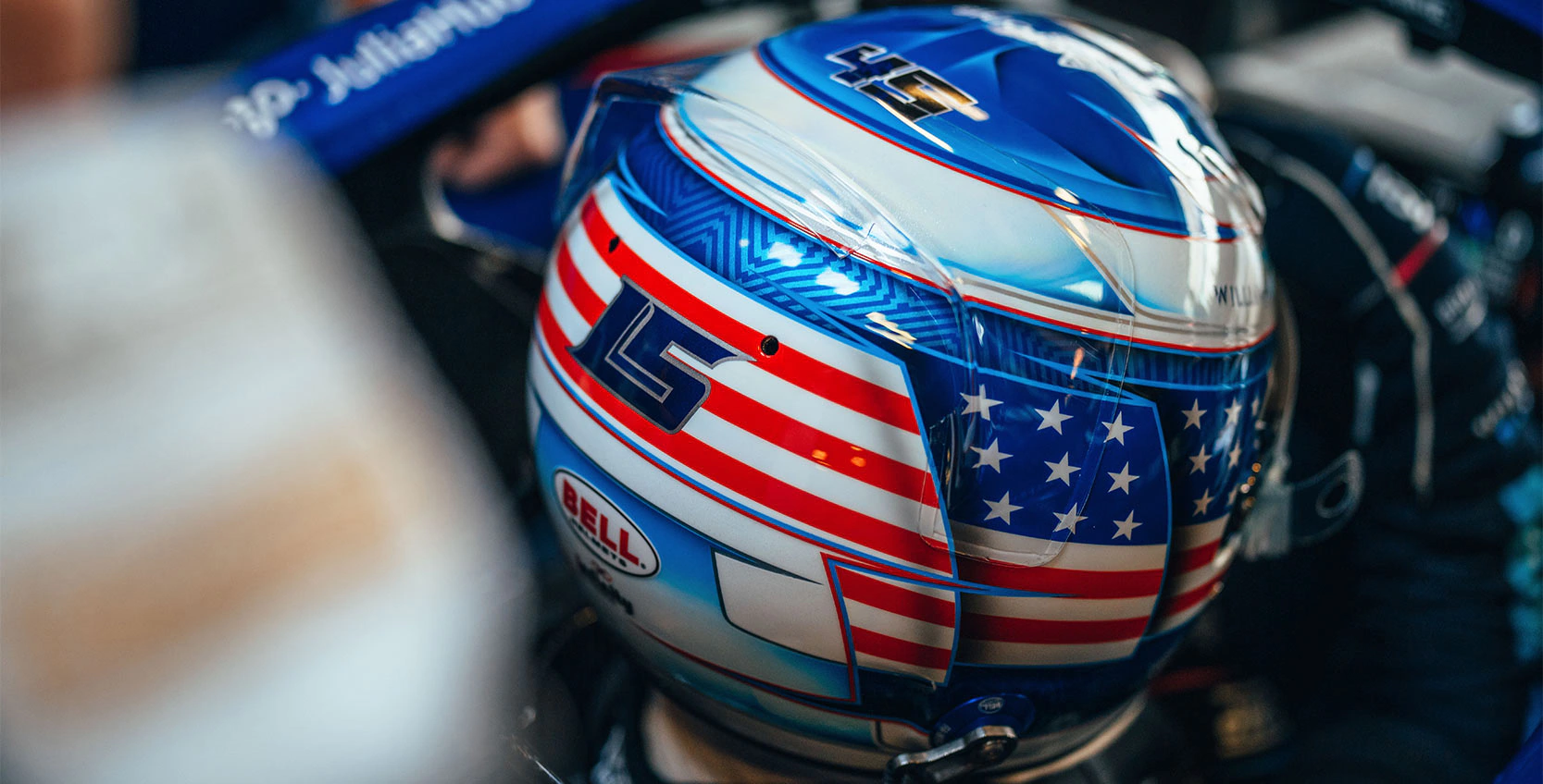 Logan Sargeant using the LS logo we created for him on the back of his helmet in Formula 1, driving for Williams Grand Prix.